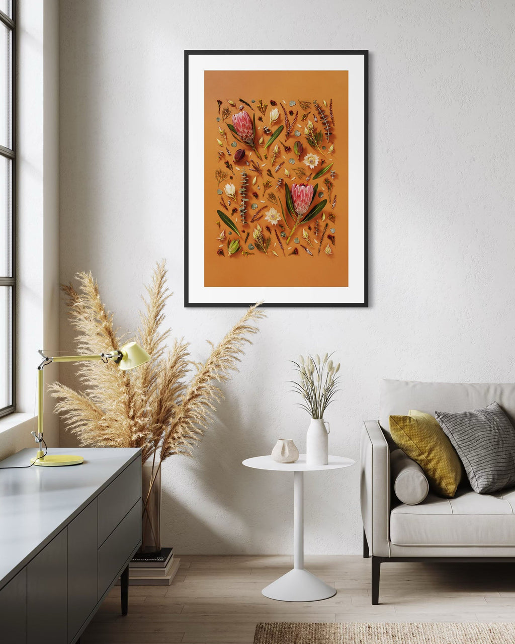 Enduring Stillness - fine art floral flatlay of proteas and eucalyptus on warm terracotta on a living room wall, from Quiet Emergence by Connie Chan.
