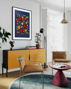 Unapologetic - fine art floral flatlay of red dahlias and gerberas on deep navy on a living room wall, from Quiet Emergence by Connie Chan.
